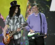 Guitarist Slash, left, plays next to Microsoft chairman Bill Gates, right, during his keynote address at the Consumer Electronics Show (CES) in Las Vegas.