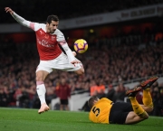 LONDON, ENGLAND - NOVEMBER 11:  Henrik Mkhitaryan of Arsenal is tackled by Ryan Bennett of Wolverhampton Wanderers during the Premier League match between Arsenal FC and Wolverhampton Wanderers at Emirates Stadium on November 11, 2018 in London, United Kingdom. (Photo by Shaun Botterill/Getty Images)